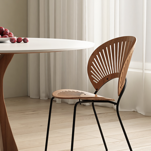 Modern wooden chair with fan-shaped back and black metal legs paired with seraphim round dining table