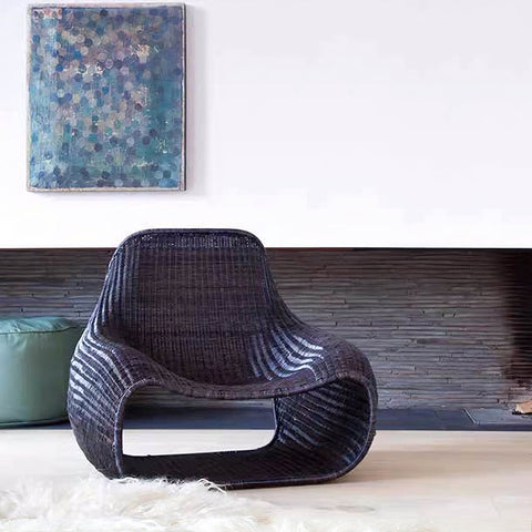 Dark woven rattan serrano outdoor lounge chair with footstool featuring a sleek modern design