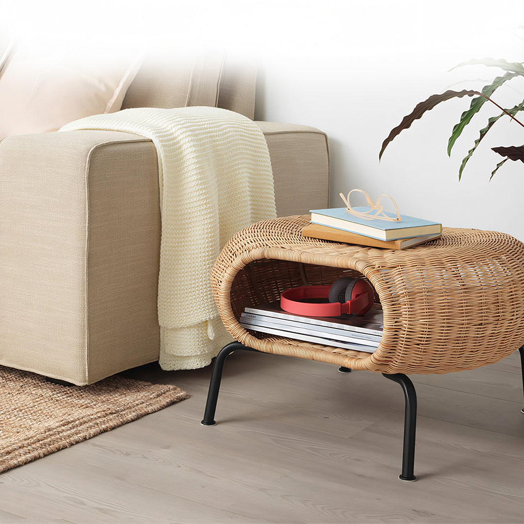 Woven rattan side table with black metal legs and curved oval design perfect for serrano outdoor lounge chair setup