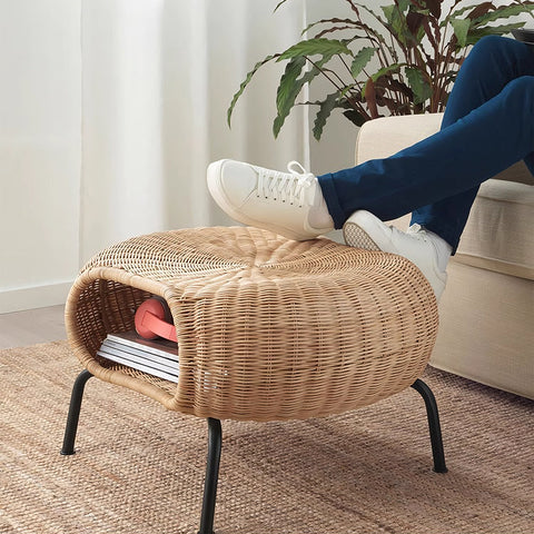 Woven wicker footstool with black metal legs paired with serrano outdoor lounge chair in rattan for relaxing outdoors