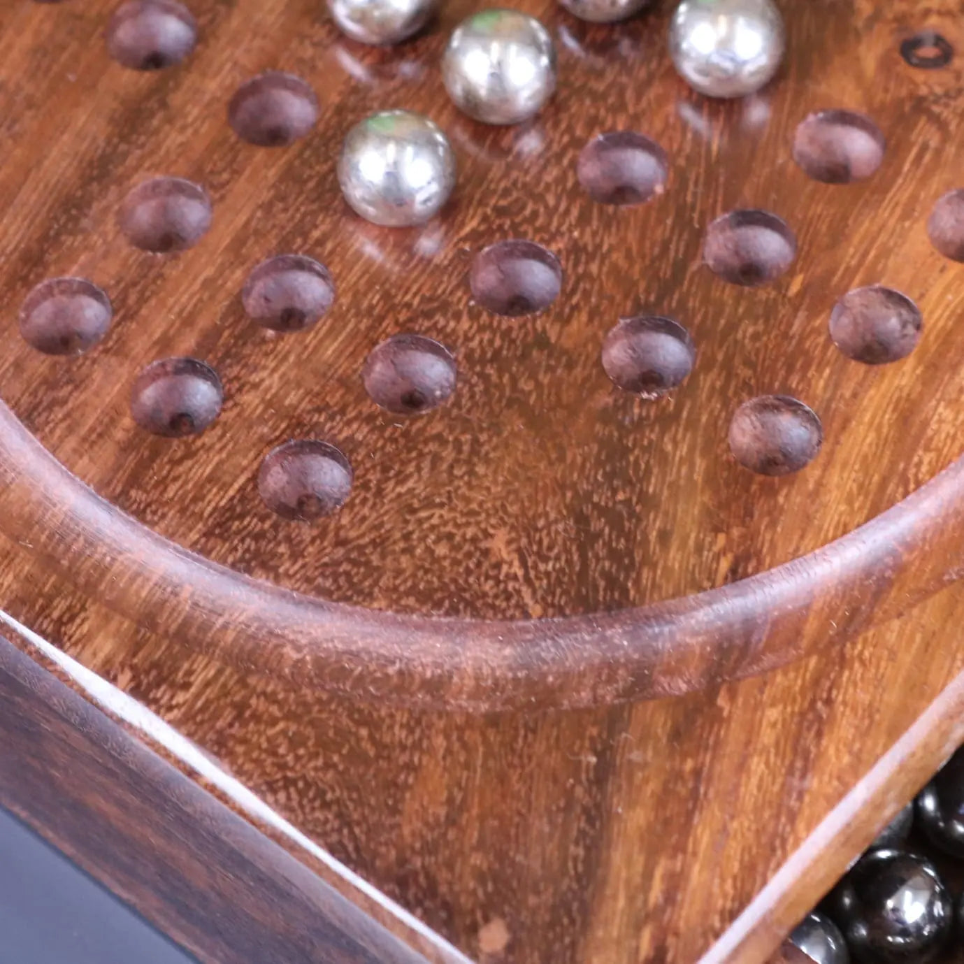Sesih pocket solitaire game with rich brown wooden board and polished steel marbles perfect for pocket solitaire fun