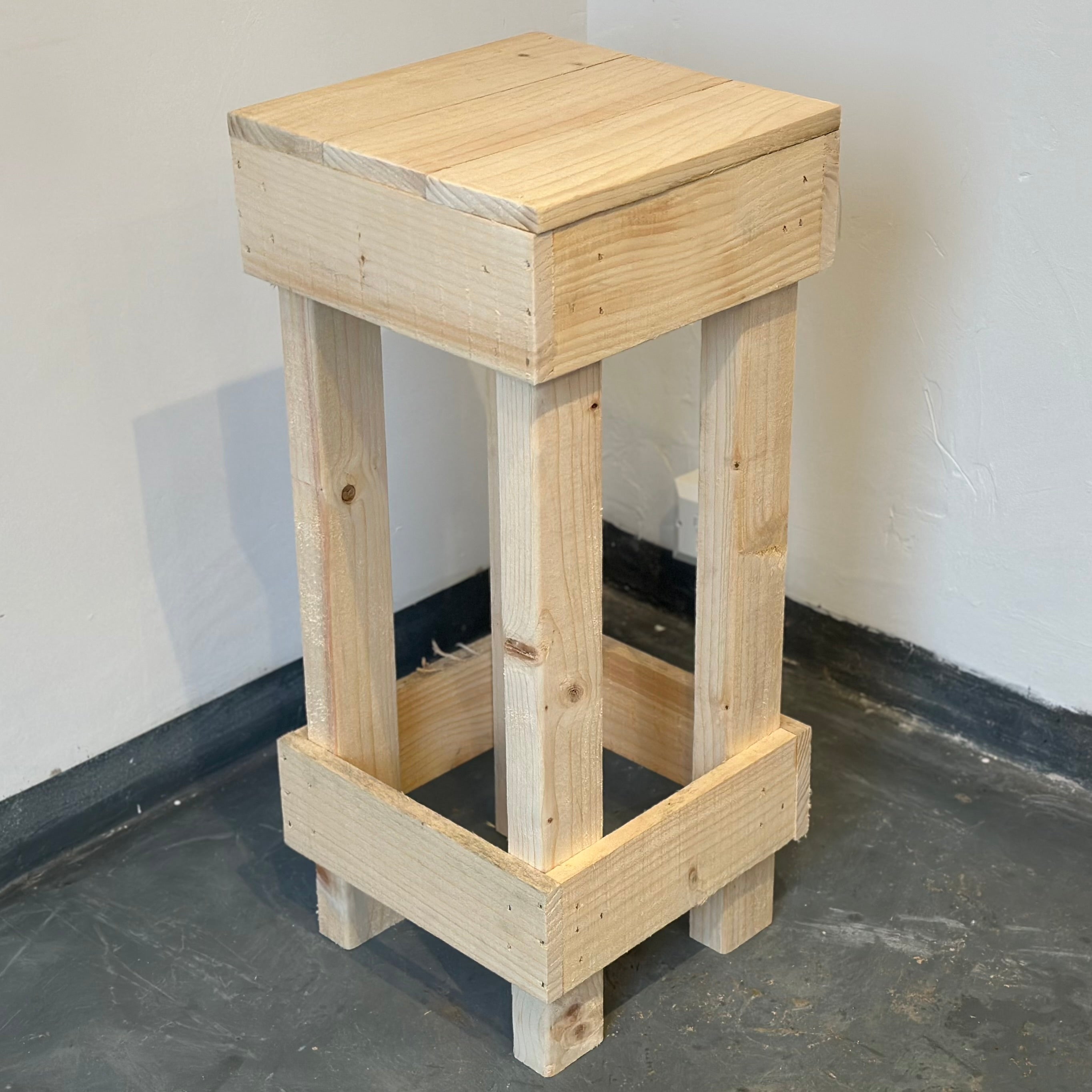 Set of 2 rustic wooden bar stools made from light-colored reclaimed wood with a simple sturdy design