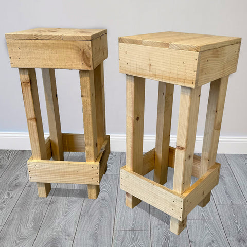 Set of 2 rustic wooden bar stools made of light-colored wood with a sturdy pallet design perfect for a home bar
