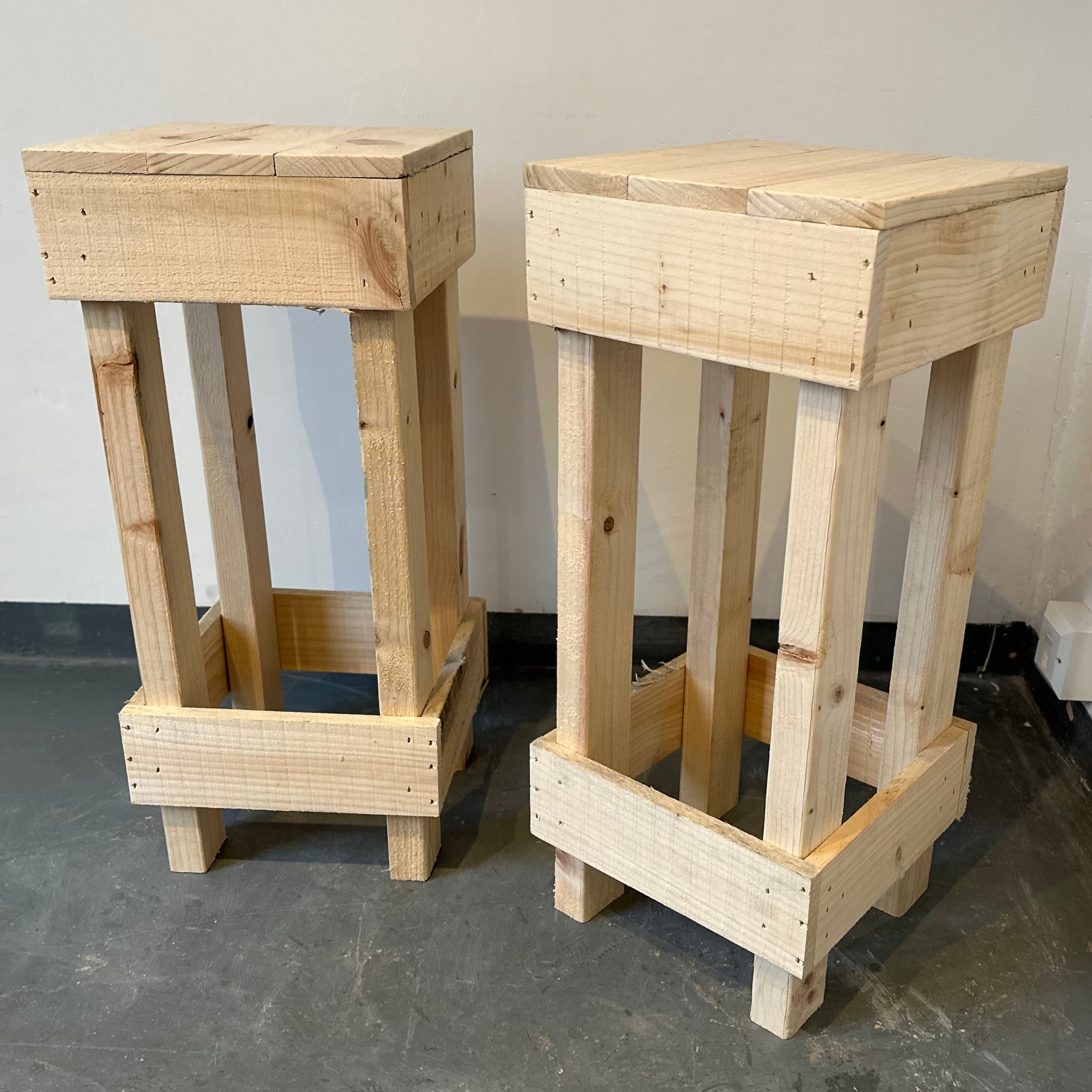 Set of 2 rustic wooden bar stools with light-colored wood and sturdy pallet design for casual seating
