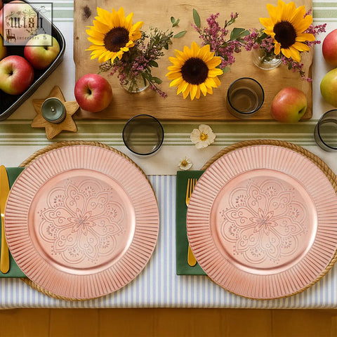 Set of 4 redbud rose gold charger plates with embossed floral patterns and fluted edges on a wide surface area