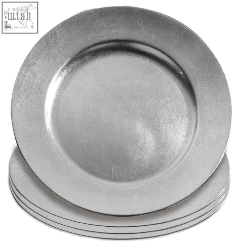 Stack of five metallic silver charger plates with a subtle brushed finish and raised rim to protect table surfaces