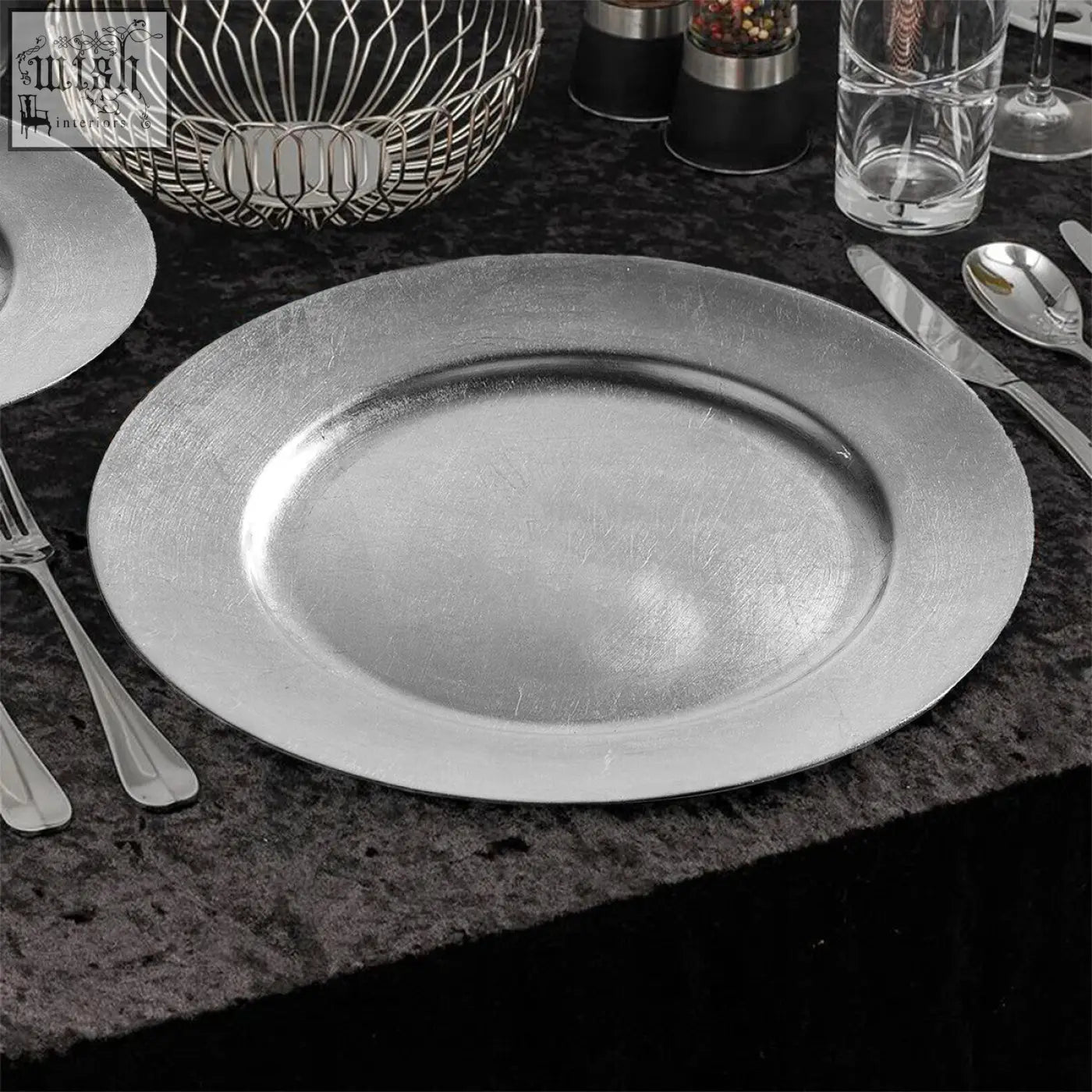 Set of four 33cm silver metallic charger plates with brushed finish and raised rim to protect table surfaces