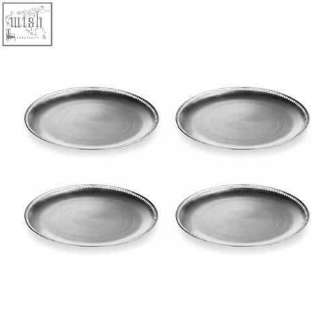 Set of four silver metallic oval charger plates with beaded edge detail to protect table surfaces with distressed finish