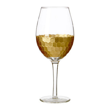 A clear astrid large wine glass with a gold honeycomb pattern on the lower half perfect for serving wine
