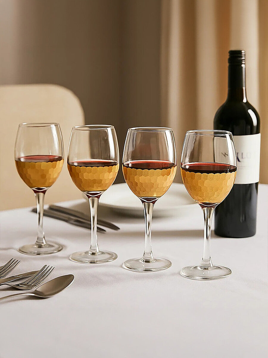 Set of four astrid small wine glasses with clear honeycomb textured bases filled with red wine perfect for small wine servings