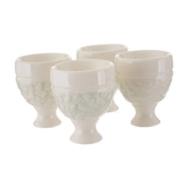 Set of five cream-colored ceramic georgia egg cups with subtle embossed diamond-patterned detailing