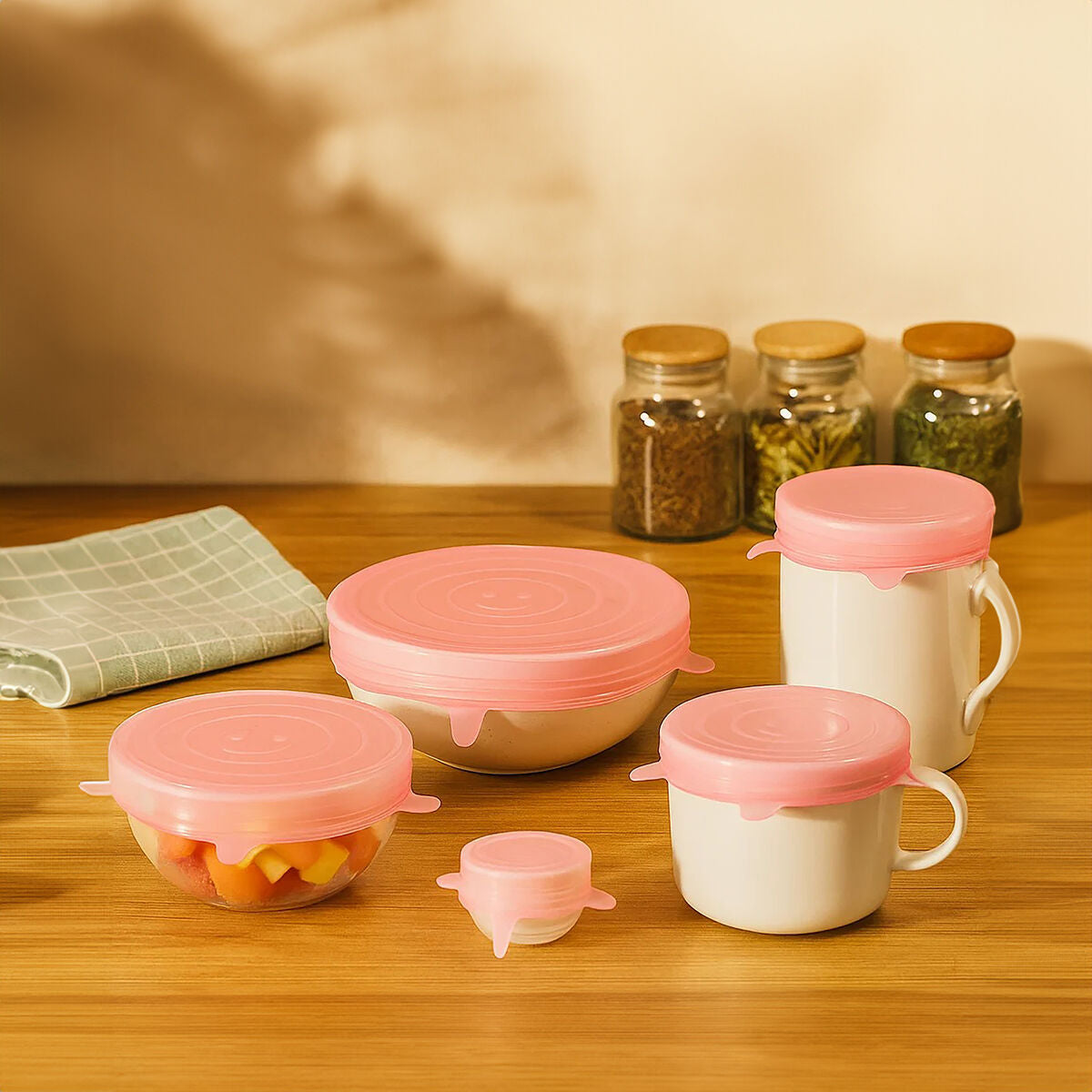 Set of six zing pink silicone lids made of stretchy pink silicone for sealing various kitchen containers easily