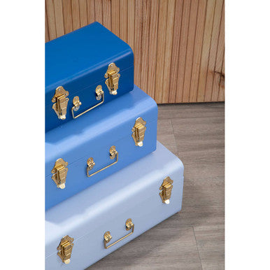 Stacked set of three assorted blue metal storage trunks with gold-tone hardware for stylish organization