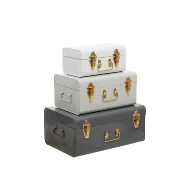 Stacked set of three assorted grey metal storage trunks in white, light gray, and dark gray with gold hardware