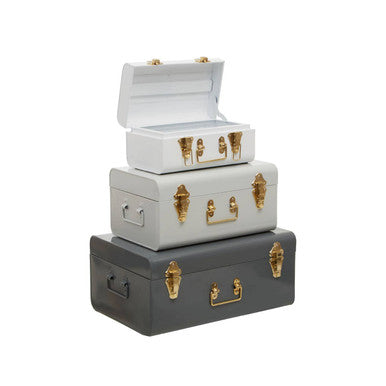 Stacked three assorted grey storage trunks in vintage style with gold-tone hardware perfect for stylish storage