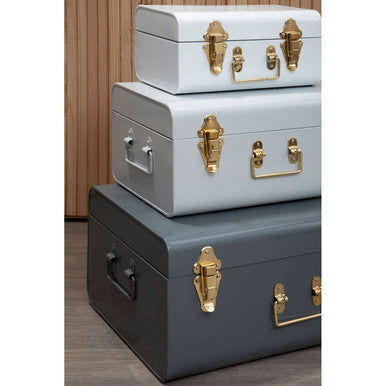 Stacked vintage-style three assorted grey storage trunks with matte finish and brass hardware from parley