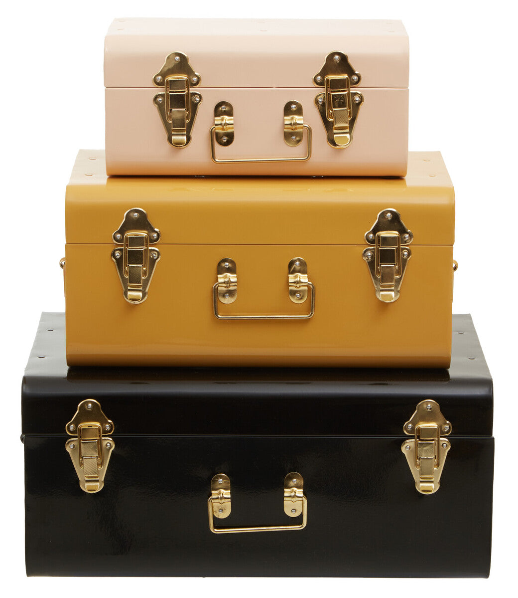 Stacked set of three assorted storage trunks in blush pink mustard yellow and black with gold metal latches and handles