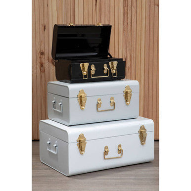 Stacked set of three monochrome storage trunks in white grey and black metal with gold-tone hardware for stylish storage