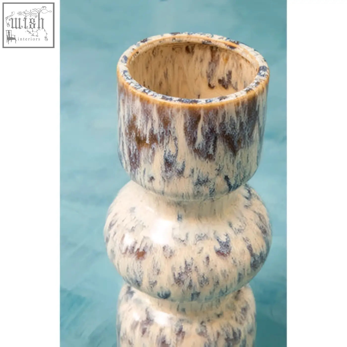 Cream-colored ceramic medium speckled vase with mottled brown and gray glaze and stacked rounded sections