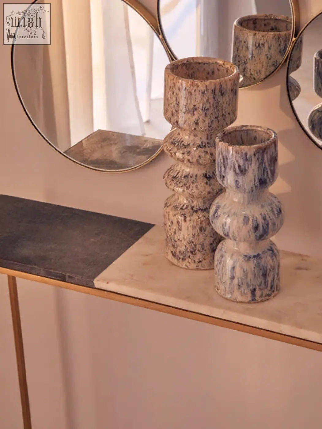 Two stacked ceramic medium speckled vases with blue and beige glaze and tiered cylindrical shapes