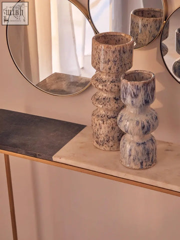 Two stacked ceramic medium speckled vases with blue and beige glaze and tiered cylindrical shapes