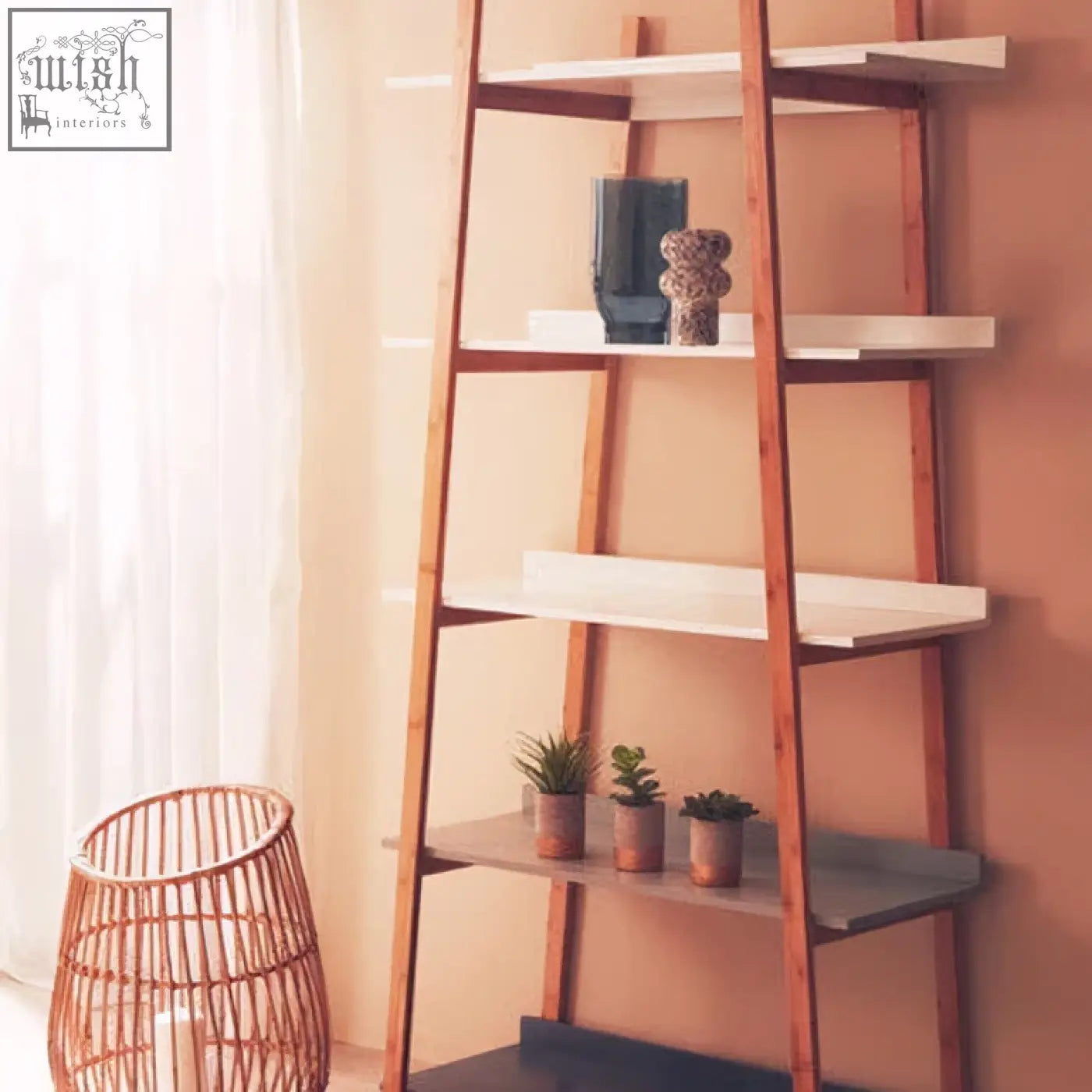Wooden ladder shelf with white and gray shelves holding small speckled vases and potted plants for decor