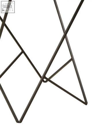Black iron base with geometric intersecting bars forming diamond shapes on shalimar marble top square side table leg