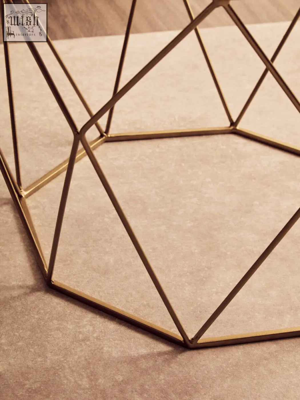 Shalimar octagon white marble coffee table with gold-toned geometric metal frame and intersecting triangular lines