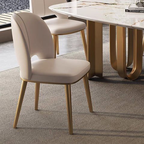 Cream-colored shankar leather dining chair with gold-tone metal legs and sleek modern design in multiple leg colours