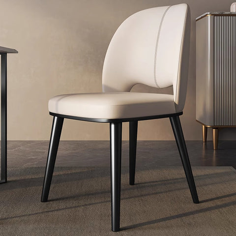 Cream-colored shankar leather dining chair with sleek black metal legs and stitched backrest detail
