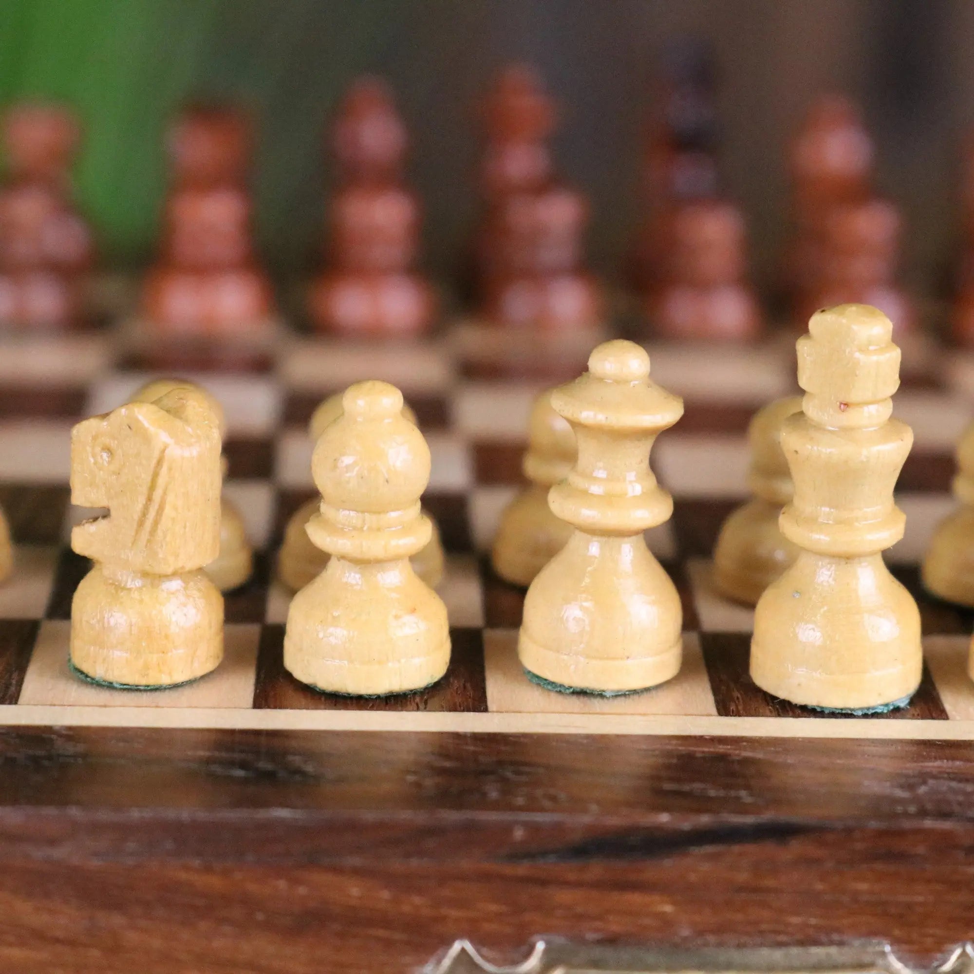 Light-colored wooden chess pieces with smooth polished surfaces in shatranj folding wooden chess set 14cm