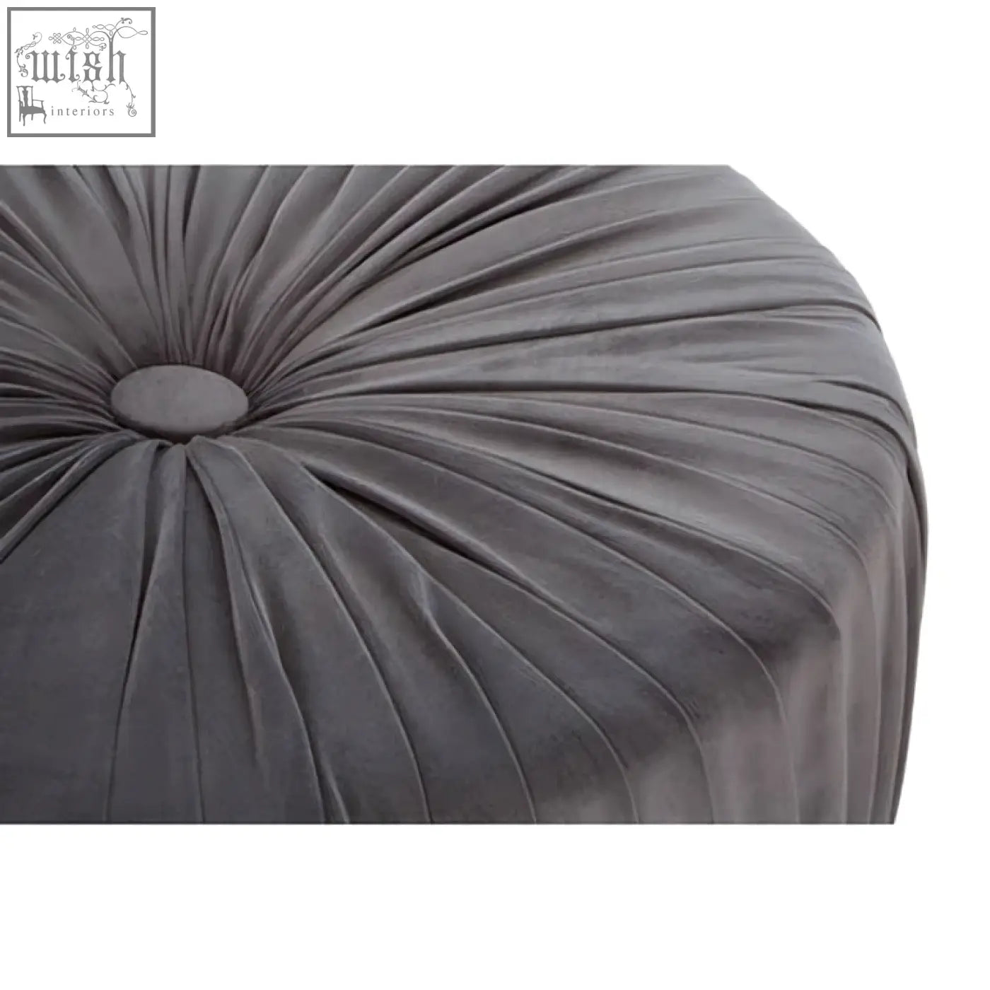 A plush dark gray velvet shea grey footstool with a circular tufted center and radiating pleats perfect for lounging