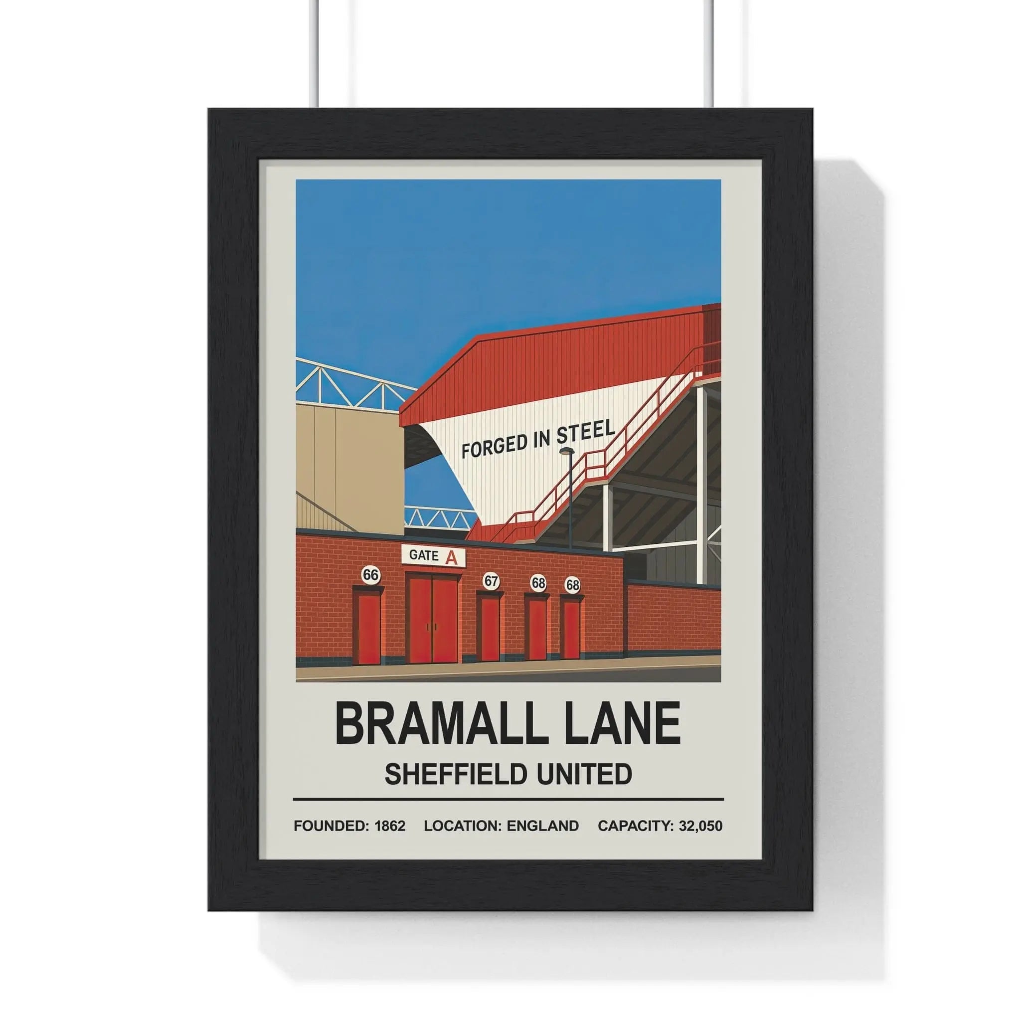 Black-framed sheffield united bramall lane stadium print with red white architecture and blue sky background