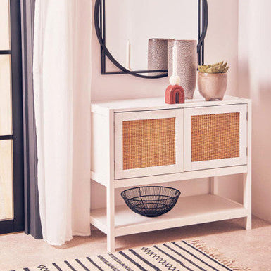 White wood rattan two drawer side cabinet with woven wicker panel doors and a lower open shelf