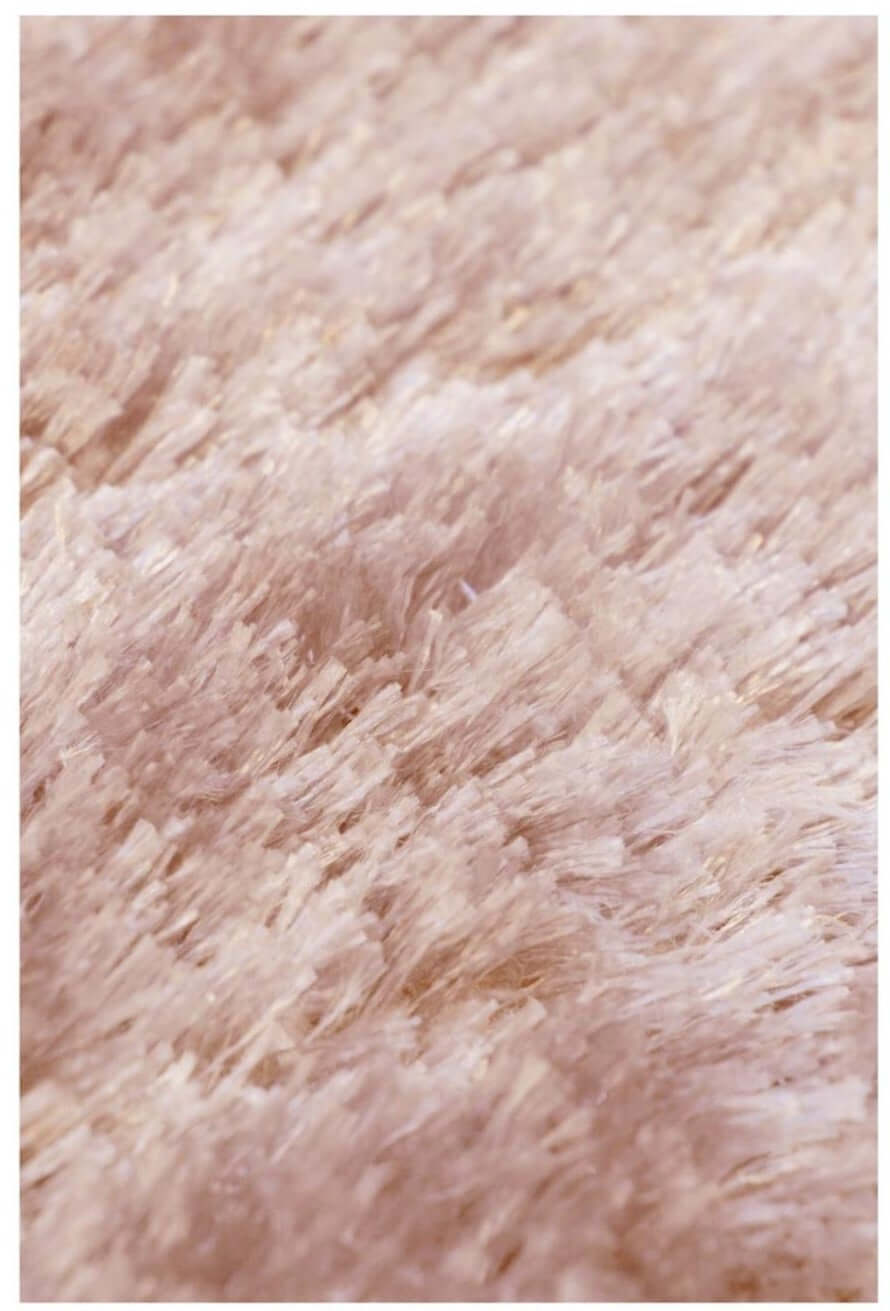 A plush shimmer pink supersoft shaggy rug with dense fluffy texture perfect for cozy home decor