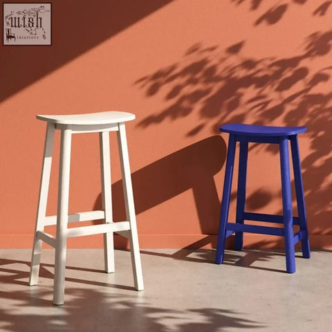 Two minimalist wooden shina bar stools in white and royal blue perfect for stylish bar seating