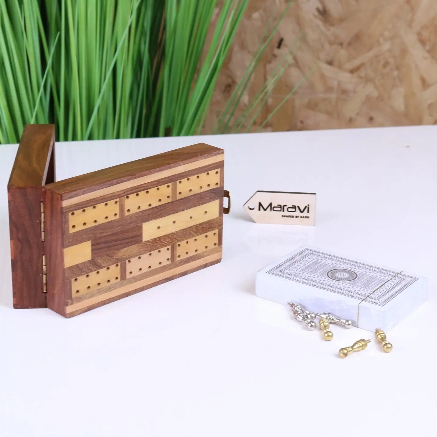 Wooden cribbage set with rich brown finish and light inlays featuring multiple peg holes ideal for travel cribbage use