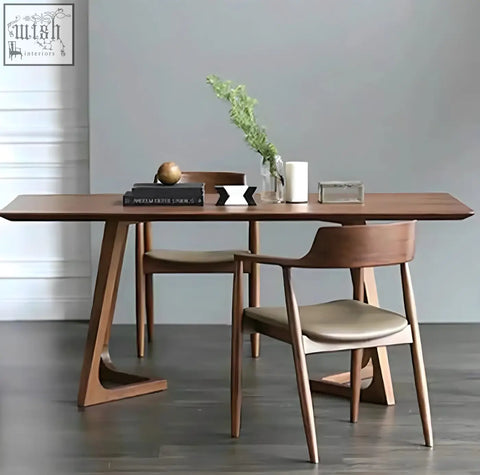 Modern walnut shoko dining table with sleek angular legs and smooth warm wood finish perfect for dining spaces