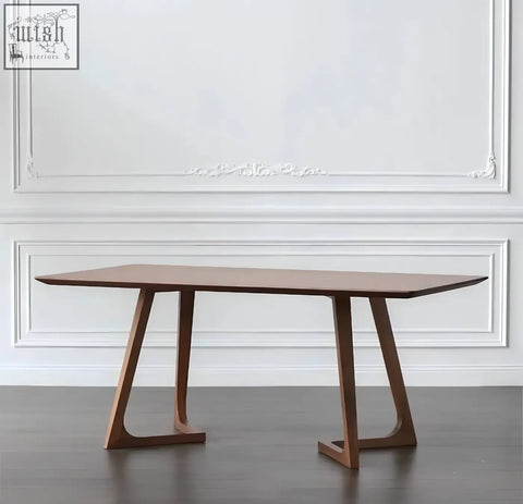 A sleek shoko dining table with rich walnut finish and distinctive angular legs perfect for modern dining spaces