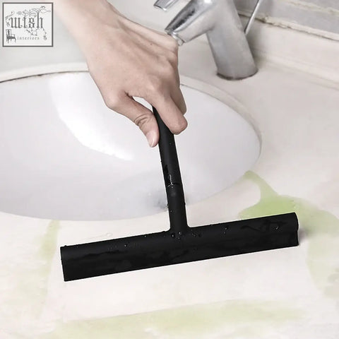 Black t-shaped shower squeegee with rubber blade silicone scraper cleans bathroom sink as a window glass wiper
