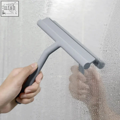 Gray silicone window glass wiper with curved handle designed for cleaning glass surfaces in bathroom and shower areas