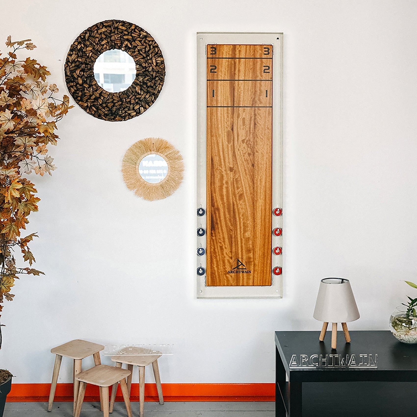 A sleek vertical wooden shuffle board game board with natural wood finish and white frame, includes hanging instructions
