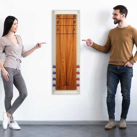 A sleek wall-mounted wooden shuffle board with natural finish and red and purple pucks includes hanging instructions and age range info