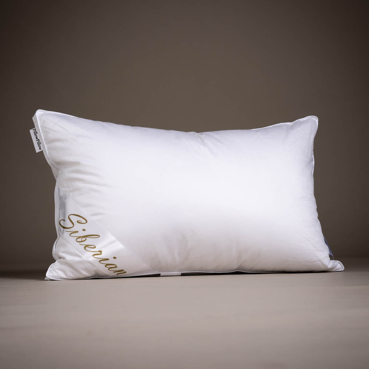 White rectangular siberian goose down pillow with gold siberian embroidery and pillowpalooza tag on corner