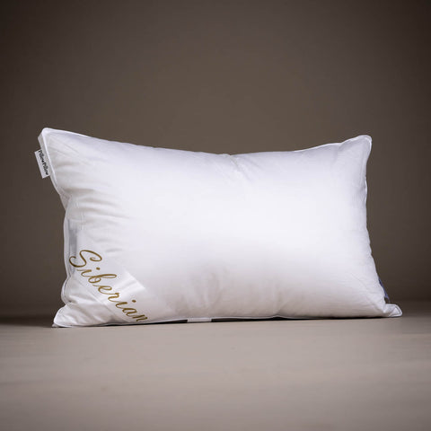 White rectangular siberian goose down pillow with gold siberian embroidery and pillowpalooza tag on corner