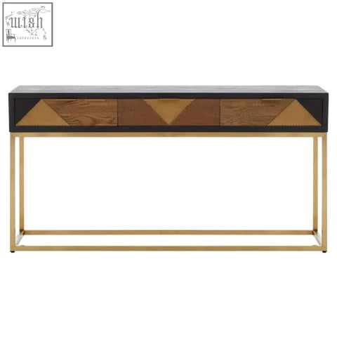 Siena console table with black top, gold console legs, and three drawers featuring geometric brass wood inlays