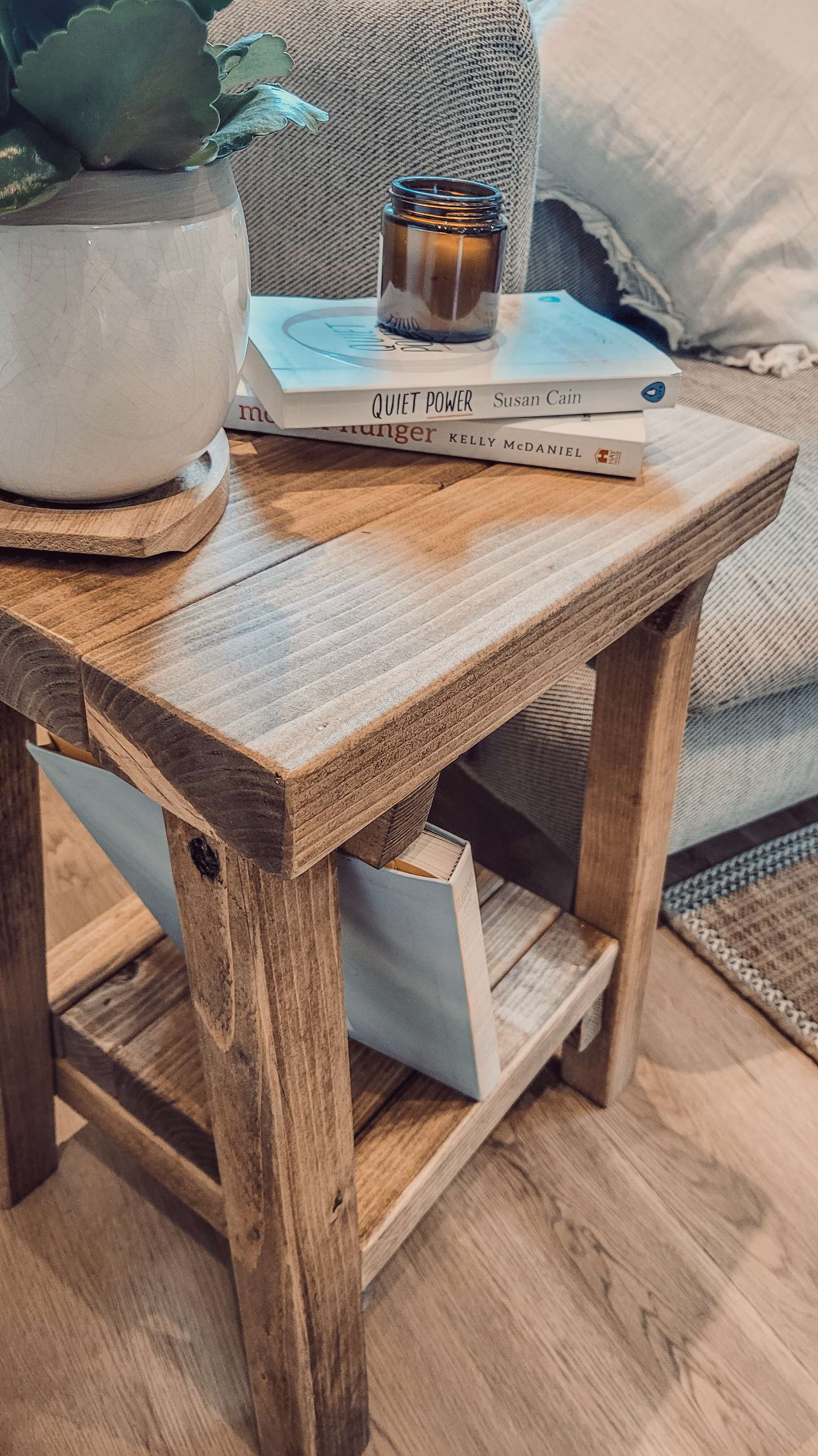 Rustic wooden siera side table with weathered finish sturdy legs and open lower shelf in light brown wood grain