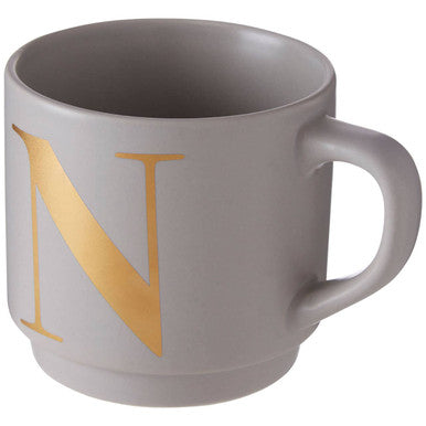 A sleek grey ceramic monogram mug featuring a bold gold n perfect for choose orsina fans
