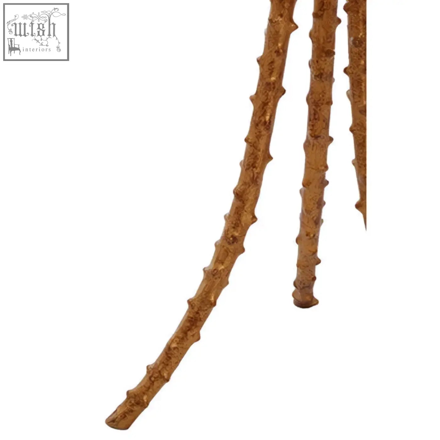 Brown textured branch-like sticks forming the triple-leg base of the sika large side table with warm gold accents