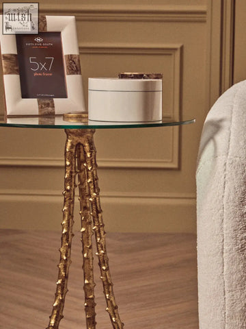 Sika large side table with warm gold textured triple-leg base and clear glass top for stylish living spaces